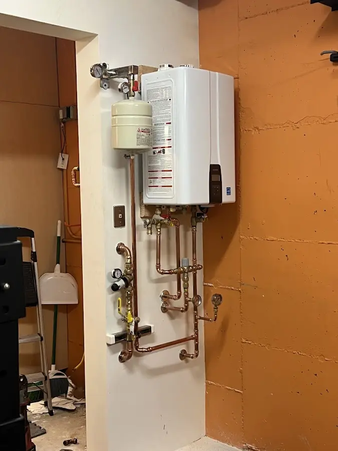 Plumbing technician inspecting water heater connections in Nevada City